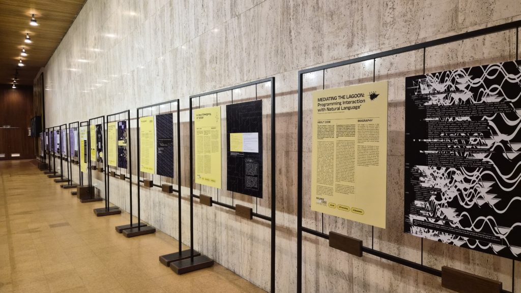 The entrance panel and the 'Source Code as Historical Testimony' section stretching down the corridor at UNESCO Paris.