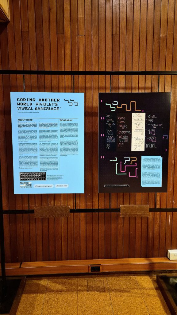 Close-up of the Rivulet panel — 'Coding Another World: Rivulet's Visual Language' — showing the bilingual format and Daniel Temkin's esoteric programming language rendered as visual art.